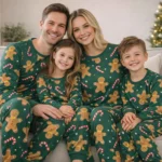 Matching family Christmas pajamas in green with gingerbread and candy cane print are designed for parents and children. The soft fabric ensures comfort during winter nights and holiday gatherings. This festive set is ideal for families who enjoy coordinated outfits and Christmas traditions.