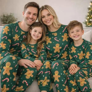 Matching family Christmas pajamas in green with gingerbread and candy cane print are designed for parents and children. The soft fabric ensures comfort during winter nights and holiday gatherings. This festive set is ideal for families who enjoy coordinated outfits and Christmas traditions.