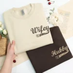 Wifey & Hubby embroidered matching hoodies with custom initials. Cozy, personalized, perfect anniversary gift.
